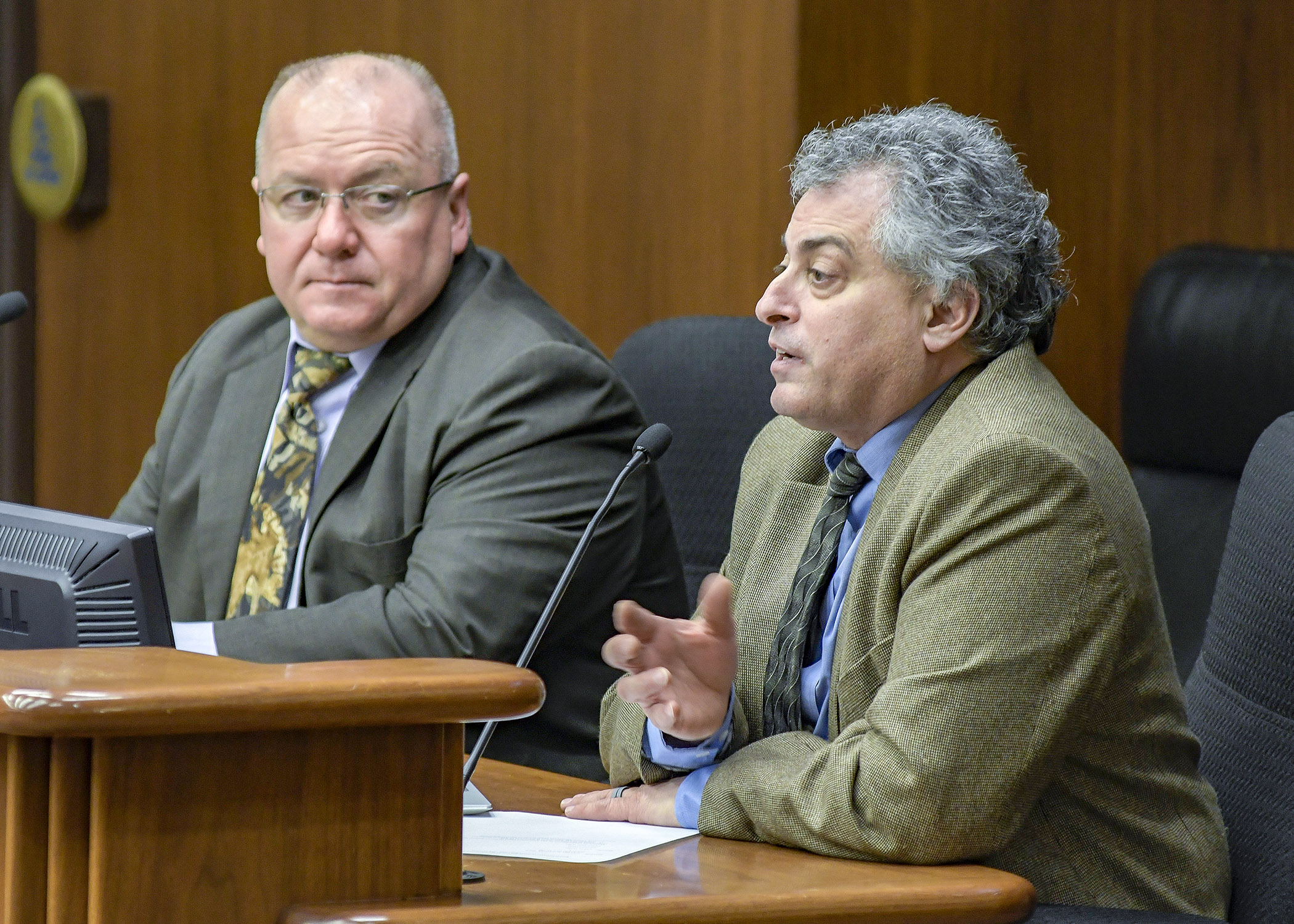 Bob Meier, left, and Lou Cornicelli testify before the House Environment and Natural Resources Finance Division Jan. 15 about Department of Natural Resources’ expenditures responding to the chronic wasting disease outbreak. Photo by Andrew VonBank
